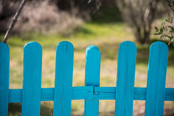 blue fence in the middle of the field