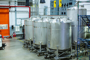 Stainless vertical steel tanks with equipment tank chemical cellar at the with scrolling wheel...