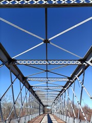 Old iron bridge with a blue sky.