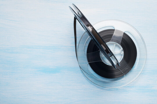 old magnetic cassettes with magnetic tape on a blue background, top view