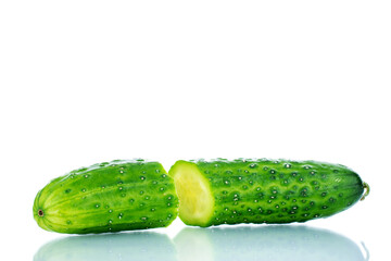 Two halves of a ripe green cucumber , macro, isolated on a white background.