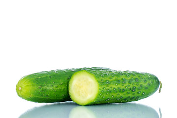 One whole and half ripe green cucumbers , macro, isolated on white background.