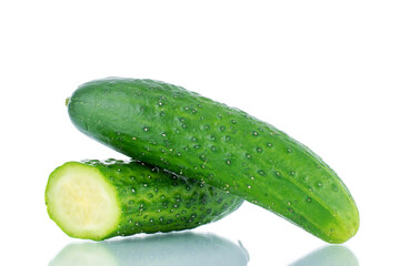 One whole and half ripe green cucumbers , macro, isolated on white background.