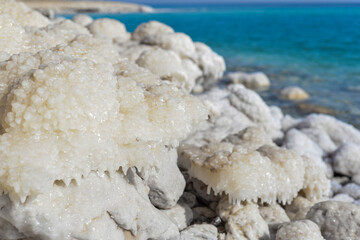 Close up of salt background. Natural salt. Dead Sea salt mineral natural formations. Salt crystals from Dead sea. View of Dead Sea coastline. Texture of Dead sea. Salty seashore rocks