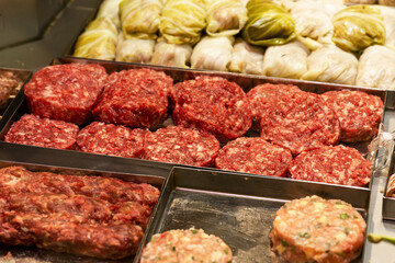 Fresh semi-finished meat products in the refrigerator in the store. Close-up.