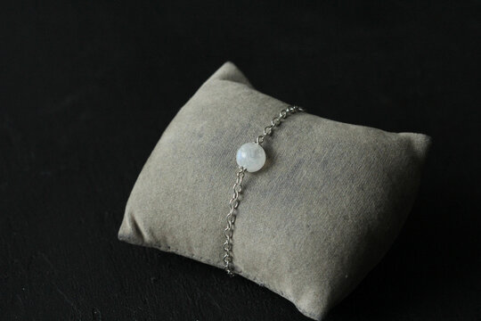 Moonstone, adularia bracelet. Bracelet made of stones on hand from natural stone Moonstone. Bracelet made of natural stones. Handmade jewelry bracelets on black modern background