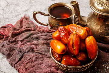 Traditional Turkish delight with Turkish tea on gray background. Ramadan Kareem celebration concept. Fragrant Turkish tea and Turkish sweets in national dishes.