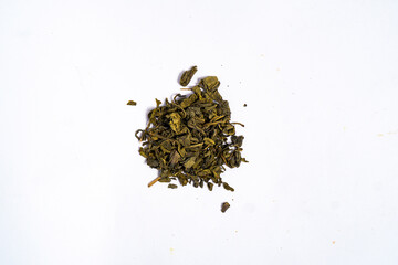 Dried green tea leaves for making tea drinks, on a white background