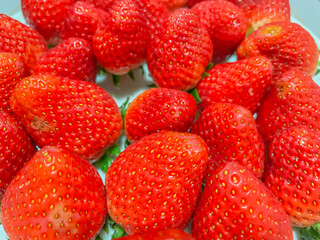 Closeup of fresh vivid red strawberry, fruit for healthy eating and diet