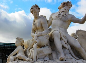 Sculpture of ancient antique Poseidon fountain in central Paris park.
