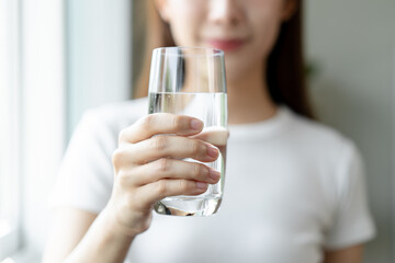 Clean freshwater concept. Woman drink mineral water in the morning for good health.