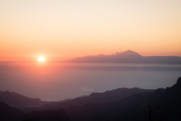 Sunset over an island from another island