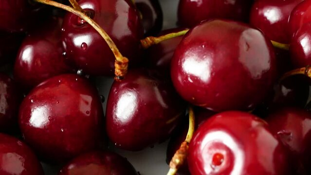 cherry on heap of fresh tasty cherries background, top view