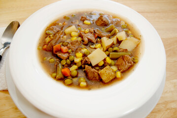 Hearty Beef Stew Served in a White Bowl, Close-Up 