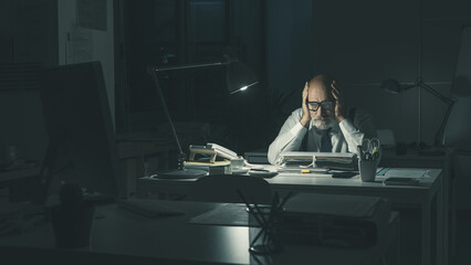 Stressed business executive working overtime