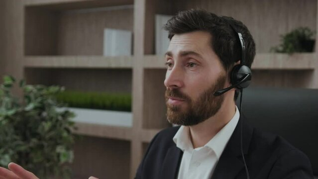 Smart-looking and representive middle-aged business consultant leads a session online conference from his office