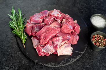 sliced ​​pieces of beef with spices on a stone background