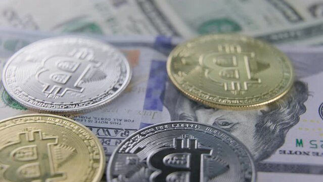 bitcoin coins lie on dollars from above close-up