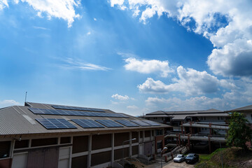 Fototapeta premium Solar cell panels on the roof with cloudy blue sky background. renewable energy concept and green energy