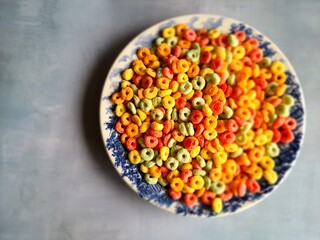 Cereals, colorful breakfast food, on a plate, top view.
