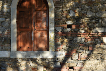 Brown historic door. Stone structure.
