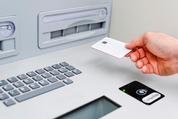 A man using an ATM with contactless technology.