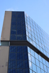 Fototapeta na wymiar Genova, Italy-January 29, 2022: Beautiful modern high-rise buildings against the sky. 3d illustration on the theme of business success and technology. clouds reflection on the mirror.Industrial zone.