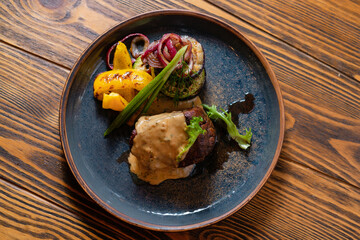 Filet mignon steak with sauces and vegetables. Menu design concept for a restaurant.