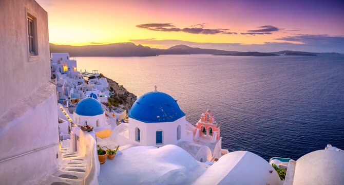 Picturesque sunrise on famous view resort over Oia town on Santorini island, Greece, Europe. famous travel landscape. Summer holidays. Travel concept background.