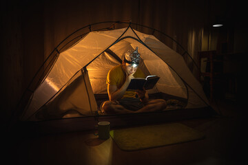 Man sitting in a tent wearing a tinfoil hat - obrazy, fototapety, plakaty