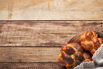 Shabbat Shalom. Bread challah with sesame seeds and poppy seeds on wooden background. Traditional...