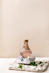 Beautiful pink transparent bottle of perfume with flowers - obrazy, fototapety, plakaty