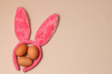 Easter attributes. Easter banner. Bunny ears and Easter eggs on pastel background