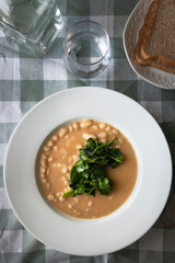 White beans with spinach. Healthy dish with vegan protein.