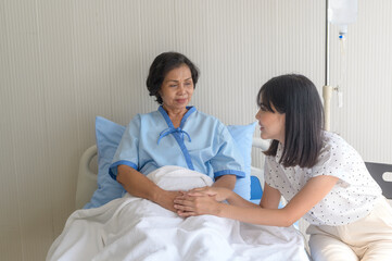Senior patient woman and her supportive daughter in hospital, health and insurance concept.