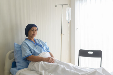 Portrait of senior cancer patient woman wearing head scarf in hospital, healthcare and medical concept