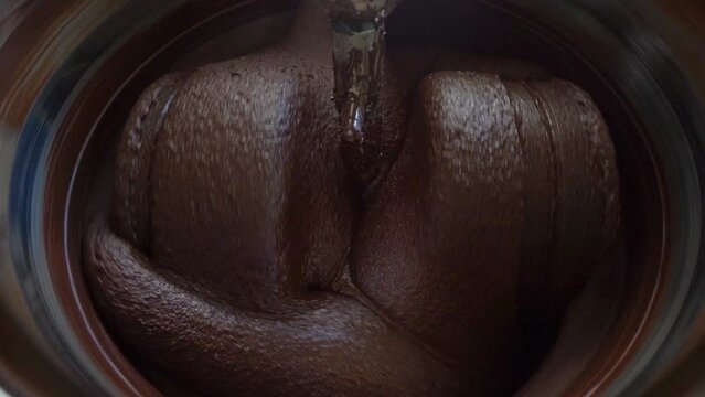 Macro Shot Of Cacao Beans Being Processed In A Conching Machine.
