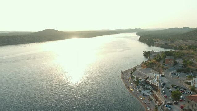 Aerial drone view of sunset over Kornati islands near the Sibenik city, Croatia. Water bay with boats and soft sun light.