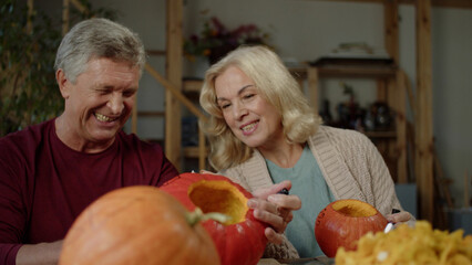 Young woman takes a slice of pumpkin from the dinner table and tastes