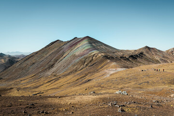 Fototapeta na wymiar Colourful Rainbow Mountains in Palccoyo (alternative to Vinicunca) with red, yellow, green, orange and blue tones and snow-covered mountain peaks outside of Cusco (Peru, South America)