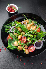 salad white beans, tomato, leaves lettuce mix petals fresh portion healthy meal food diet snack on the table copy space food background keto or paleo diet veggie vegan or vegetarian food no meat