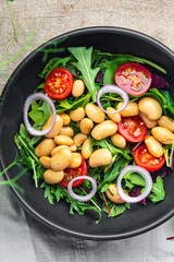 salad white beans, tomato, leaves lettuce mix petals fresh portion healthy meal food diet snack on the table copy space food background keto or paleo diet veggie vegan or vegetarian food no meat