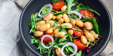 salad white beans, tomato, leaves lettuce mix petals fresh portion healthy meal food diet snack on the table copy space food background keto or paleo diet veggie vegan or vegetarian food no meat
