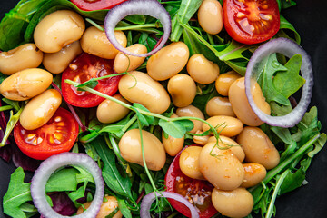 salad white beans, tomato, leaves lettuce mix petals fresh portion healthy meal food diet snack on the table copy space food background keto or paleo diet veggie vegan or vegetarian food no meat