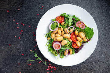 salad white beans, tomato, leaves lettuce mix petals fresh portion healthy meal food diet snack on the table copy space food background keto or paleo diet veggie vegan or vegetarian food no meat