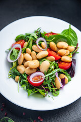 salad white beans, tomato, leaves lettuce mix petals fresh portion healthy meal food diet snack on the table copy space food background keto or paleo diet veggie vegan or vegetarian food no meat