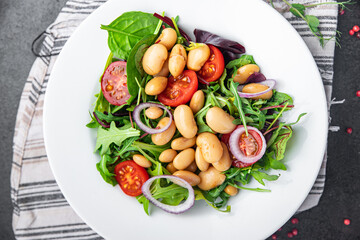 salad white beans, tomato, leaves lettuce mix petals fresh portion healthy meal food diet snack on the table copy space food background keto or paleo diet veggie vegan or vegetarian food no meat