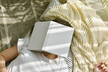 Woman fall asleep while reading a book, Girl resting and chilling with soft and comfort knit...