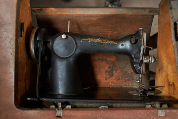 Old, retro, vintage sewing machine and on a dark background
