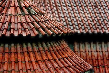 Obraz na płótnie Canvas traditional terracotta roof tile pattern viewed from above in capital of Czech Republic Prague city